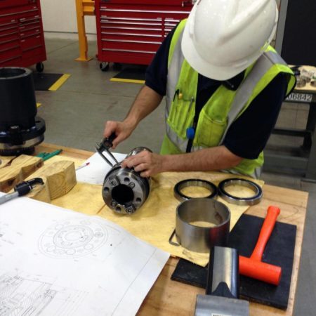 Amentum Caterpillar Technician installing high precision bearings