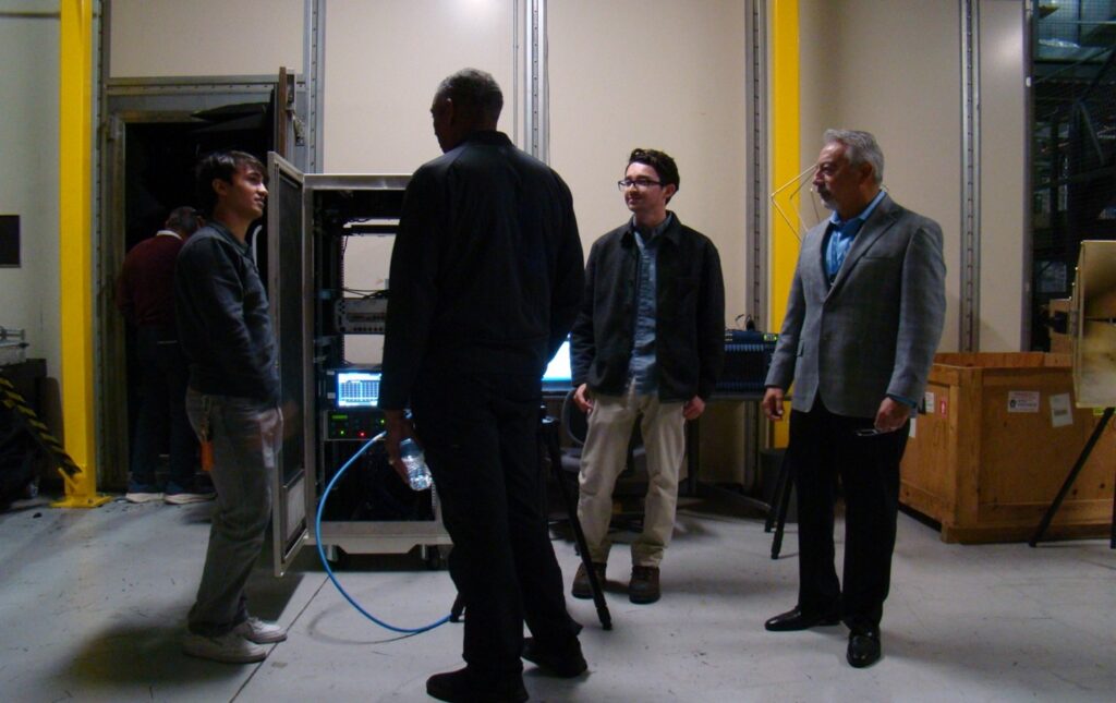 Anechoic facility engineers explain the electronic warfare test setup to retired General Vincent K. Brooks an executive board member