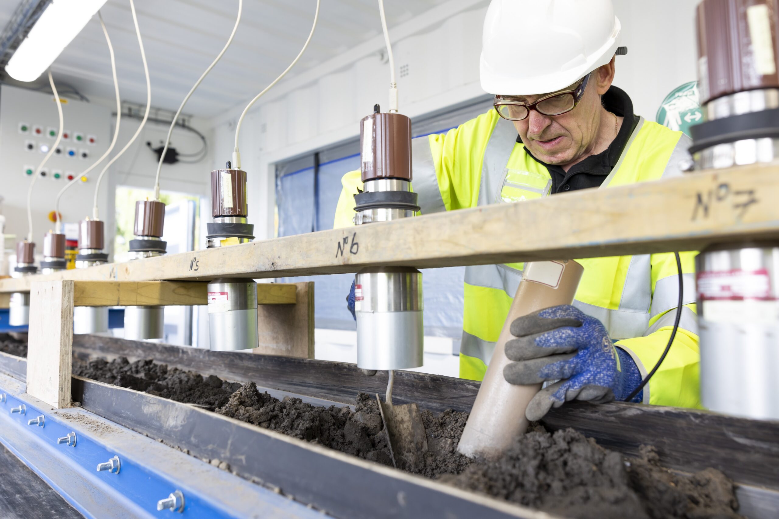 A worker in safety gear working on radiation protection science