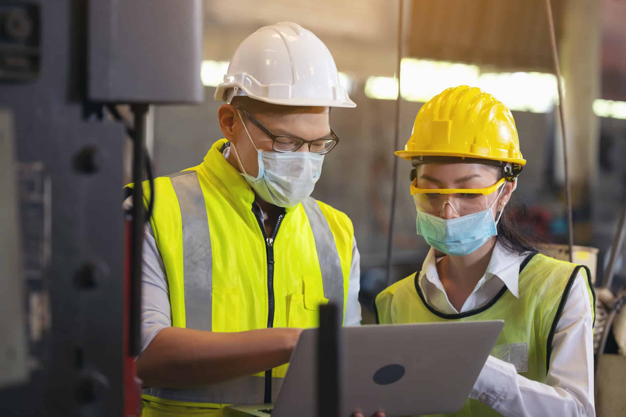 Two,Engineer,In,Hard,Hat,Wearing,Safety,Using,Laptop,For